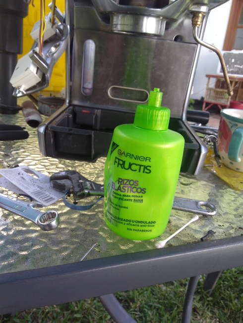 green plastic bottle with perfect nozzle fit. No measurements provided.