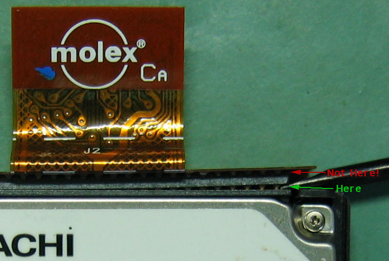 closeup of prying apart CF connector correctly, between plug and socket made of the same material